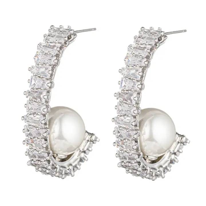 NEW EYE CANDY AVA HOOP EARRINGS: This pair of Ava Half Loop earrings showcases a luxurious combination of shimmering zirconia crystals and a radiant glass pearl centerpiece. Designed with a unique half-loop structure, these gold earr