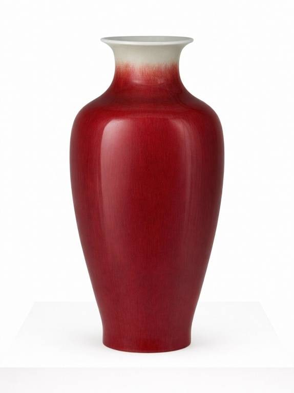SANG DE BOEUF STYLE PORCELAIN FLOOR VASE 16.5": Striking tall porcelain vase featuring a rich oxblood red glaze with soft gradient transition to a pale celadon-toned rim, executed in the traditional Sang de Boeuf style. The form presents a classic 
