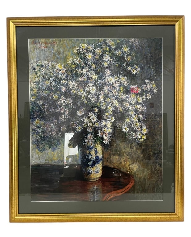 CLAUDE MONET PRINT WITH FRAME 38": Framed print depicting a floral still life after Claude Monet, featuring a vase with white and yellow flowers. The print is matted and set in a gold-tone wooden frame. | | Measures approximately: 33" 