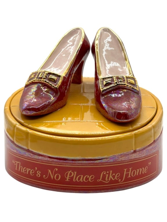 WIZARD OF OZ CERAMIC BOX BY STAR JAR CO: Wizard of Oz ceramic cookie jar featuring Dorothy’s iconic ruby slippers displayed on a yellow brick road-style lid, set atop a round red and iridescent glazed base with the phrase “There’s No P