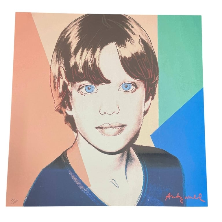 AFTER ANDY WARHOL SIGNED CHILD PRINT 23.5": Colorful pop art style portrait print after Andy Warhol, depicting a young child with blue eyes against a bold geometric background in peach, cream, teal, and bright blue tones. The lower right bears 