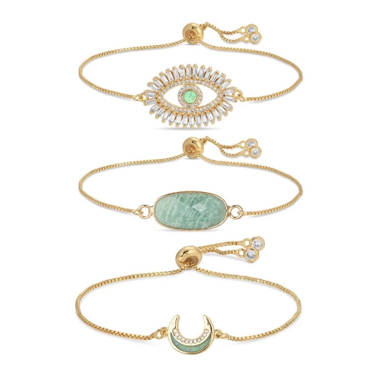 JULES 3 PIECE BOLO BRACELET SET: New Eye Candy Jules 3 Piece Bolo Bracelet Set. Includes dainty brass chains with evil eye, crescent moon, and natural gemstone charms. Stone type: natural. Approx. 3" diameter. Lobster claw closure. S