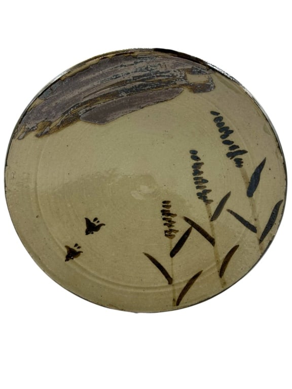 OLD CHINESE ONDA KILN STUDIO POTTERY CHARGER 15": Large studio pottery charger or shallow bowl attributed by underside note to Old Onda Kiln, Finley 20th C., featuring a warm cream glazed ground with brown and black abstract brushwork, cattail-style 