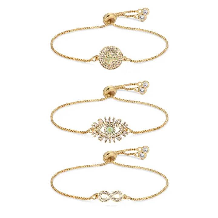 NEW EYE CANDY INFINITY CROSS & EYE BRACELET: New Eye Candy Infinity, Cross & Eye Bracelet Set. Gold tone material, adjustable sliding closure, includes three bracelets with distinct infinity, cross, and eye motifs. Shipping Available at www.DeJa