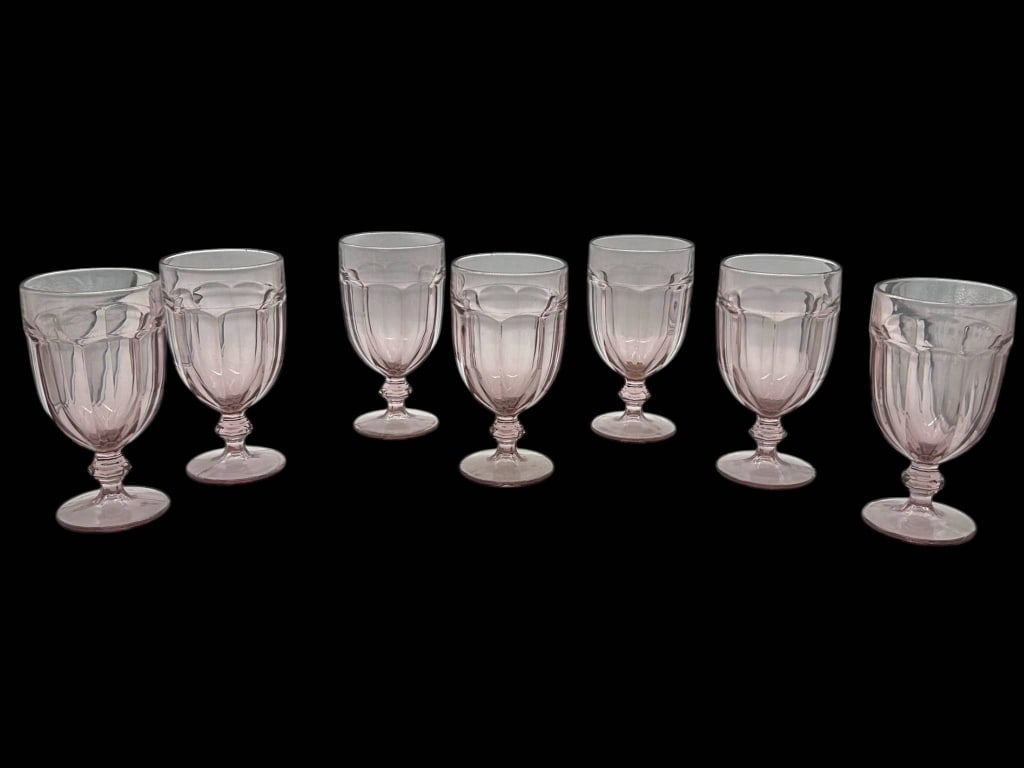 7 PINK TINTED PRESSED GLASS PEDESTAL PANELED GOBLE: Charming set of 7 pink tinted pressed glass goblets featuring a paneled/fluted bowl design, short decorative stems, and round pedestal bases. The soft blush-pink glass gives the set a pretty vintage-i