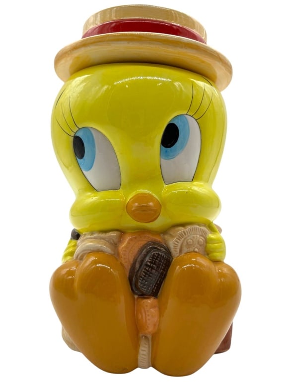 VINTAGE TWEETY BIRD CERAMIC COOKIE JAR 12": Vintage Tweety Bird ceramic cookie jar, measuring approximately 12 inches tall and 6 inches wide. Stamped 1993 Warner Bros. Inc. | Overall condition is good with no visible chips or cracks. Minor surf