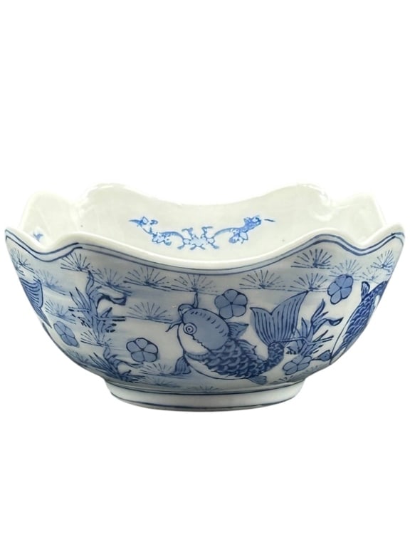 BLUE AND WHITE PORCELAIN FISH MOTIF BOWL 6": Decorative blue and white porcelain bowl featuring a scalloped rim, square-rounded form, and classic underglaze-style cobalt decoration with koi fish, aquatic plants, florals, and interior botanical a