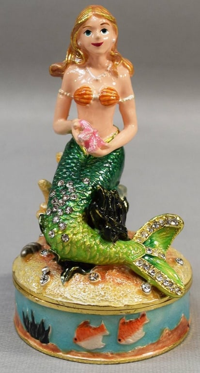 ENAMEL MERMAID TRINKET BOX WITH JEWELS: Colorful enamel trinket box featuring a mermaid with green tail, detailed with sparkling jewel accents. Seashell and ocean design on base. Ideal for jewelry or keepsakes. Shipping Available at www.DeJ