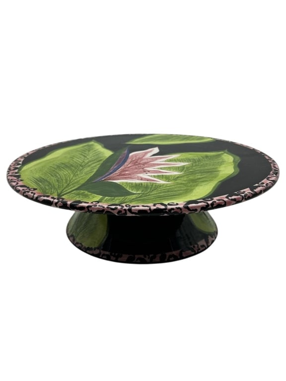 LAURIE GATES POTTERY SERVING STAND 11.5": Laurie Gates decorative fish-form pedestal serving dish, made in USA, featuring a glossy black ground with bold tropical green leaf decoration, pink floral accent, and patterned pink-and-black border.
