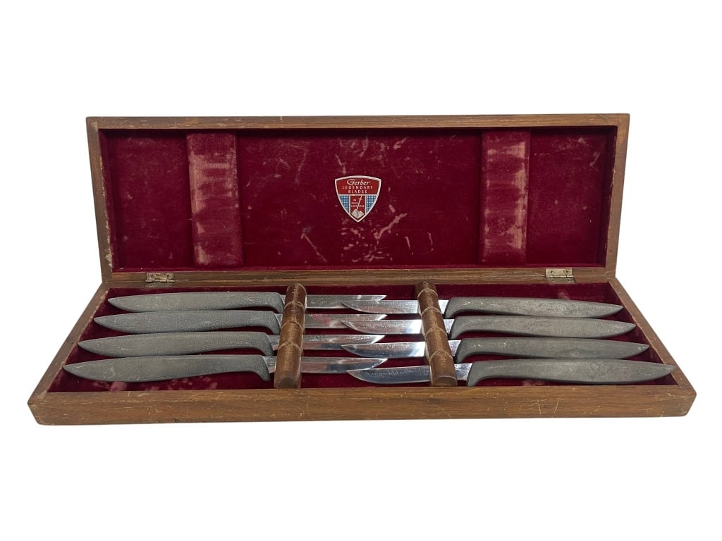 VINTAGE CUTLERY SET WITH WOODEN CASE: Vintage cutlery set of 8 knives housed in a red velvet-lined wooden case. Includes the original case with a crest inside the lid. Estimated knife length about 8.5 inches. Case measures 16" wide. | |