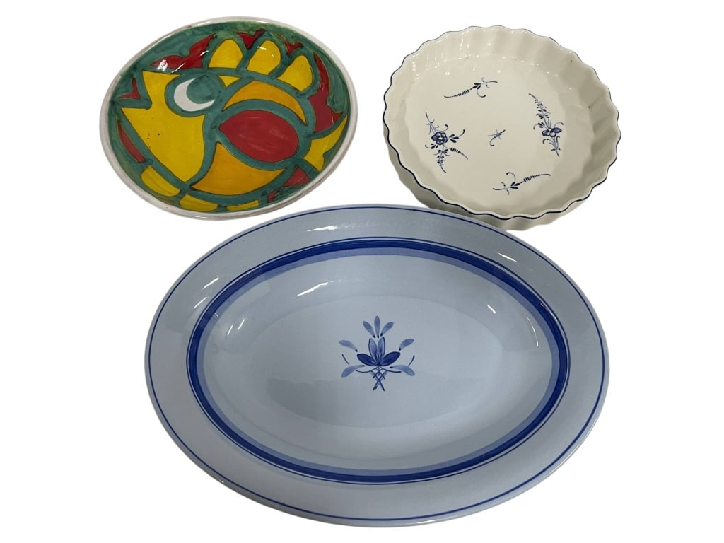 THREE DECORATIVE CERAMIC SERVING DISHES 13": Three ceramic serving dishes: one marked 'Desimone Italy' with colorful abstract design, one white dish with blue floral motifs, and one oval dish with blue trim and floral motif. | | The largest