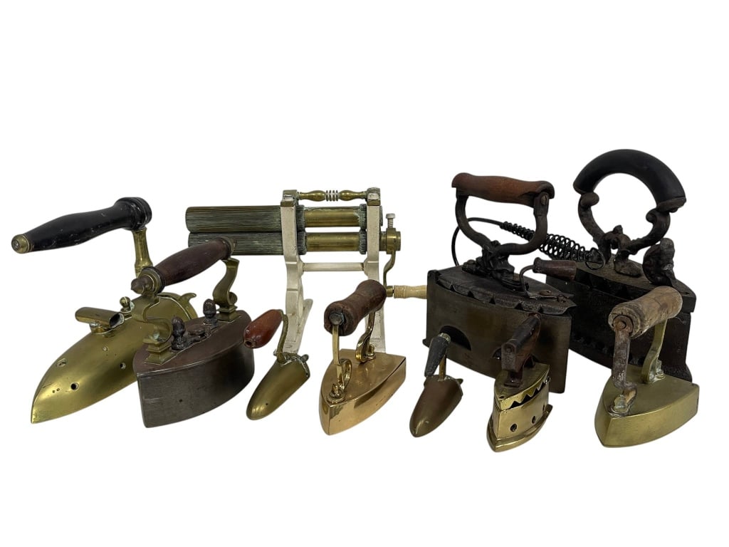 LARGE ANTIQUE IRON AND CLOTHES WRINGER LOT: Large assorted collection of antique and vintage clothing irons and laundry tools, including brass and cast iron sad irons, wood-handled pressing irons, charcoal or box-style irons, a fluting/crimping