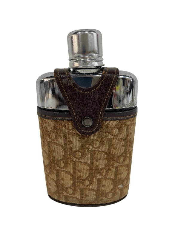 CHRISTIAN DIOR MONOGRAM FLASK 7": Christian Dior flask with signature monogram canvas and metal cap. Leather trim and snap closure. Shipping Available at www.DeJaVuAuctionShipping.com. By bidding in this auction you agree that you hav
