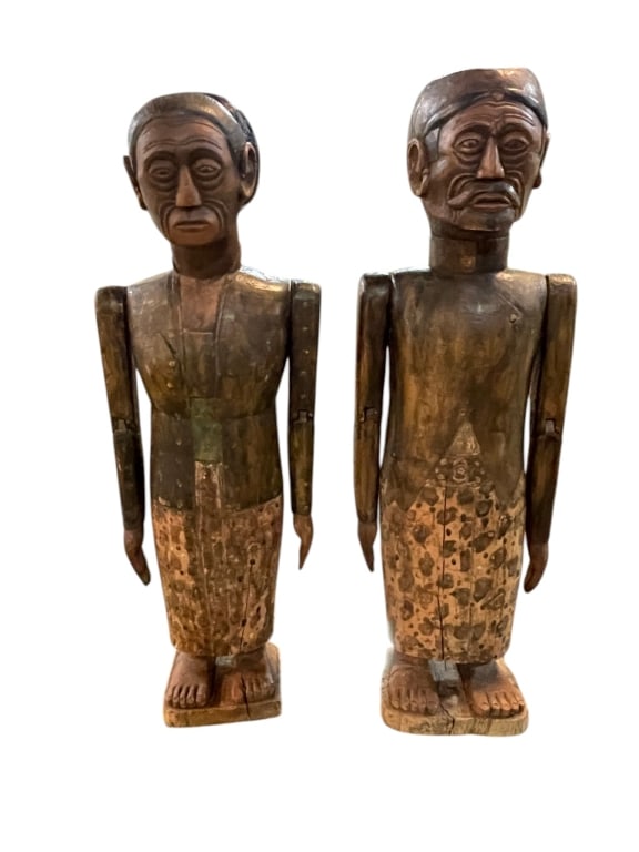 HAND CARVED JAVANESE ANCESTOR SPIRIT STATUES 29": LOT OF 2 hand carved artwork in the form of spirit derived from ancestors of the Borneo/Java origin. Both man and woman together, stand 29" tall, jointed arms and detail accented body and cloth worn. 