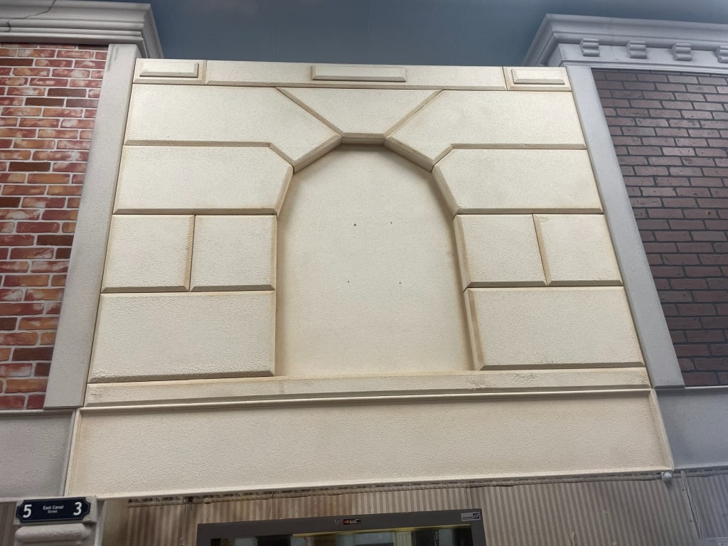 NYC INDOOR CITY FAUX CONCRETE BUILDING FACADE 9FT: LOCATION: 35EC SE corner. Single face facade. Must be removed. FACADES are sold as shown in pictures, for visualization the ceiling is 19 feet tall and the columns are 7 foot. If the facade is paralle