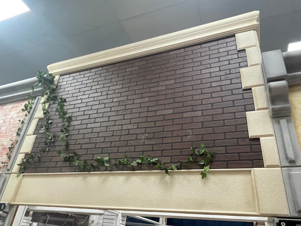 RED BRICK CREAM TRIM BUILDING FACADE: FACADES are sold as shown in pictures, for visualization the ceiling is 19 feet tall and the columns are 7 foot. If the facade is parallel to column the measure will be approx from the column up. If t