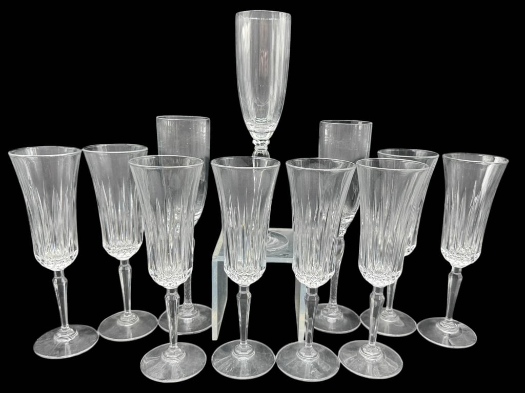 12 CUT CRYSTAL CHAMPAGNE FLUTES: 12 cut crystal champagne flutes. Each flute features faceted detailing and elegant stems. Shipping Available at www.DeJaVuAuctionShipping.com By bidding in this auction you agree that you have read Th