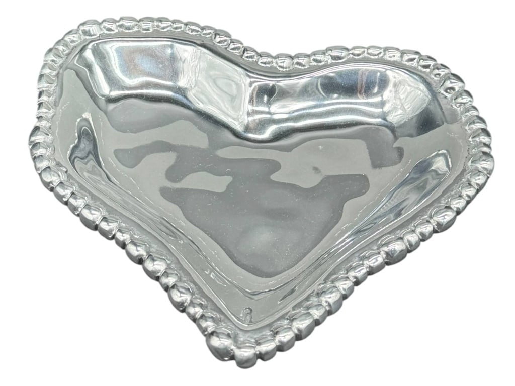 PEWTER HEART TRAY WITH BEADED EDGE: Pewter heart-shaped tray featuring a beaded edge design. Tray measures approximately 7 inches at its widest point. Shipping Available at www.DeJaVuAuctionShipping.com. By bidding in this auction you a