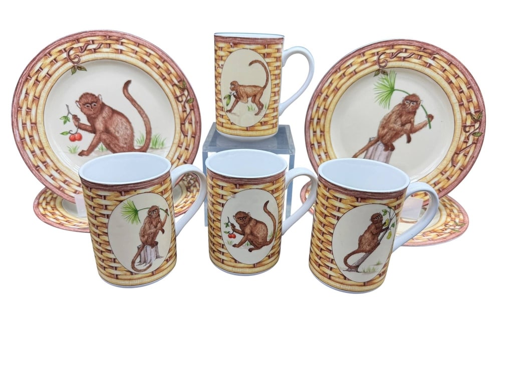 AMERICAN ATELIER MONKEY PORCELAIN SET: American Atelier Monkey series porcelain set includes plates and mugs, each featuring a monkey motif with a basket-weave border. Dishwasher and oven safe. Made in China. Shipping Available at www.DeJa