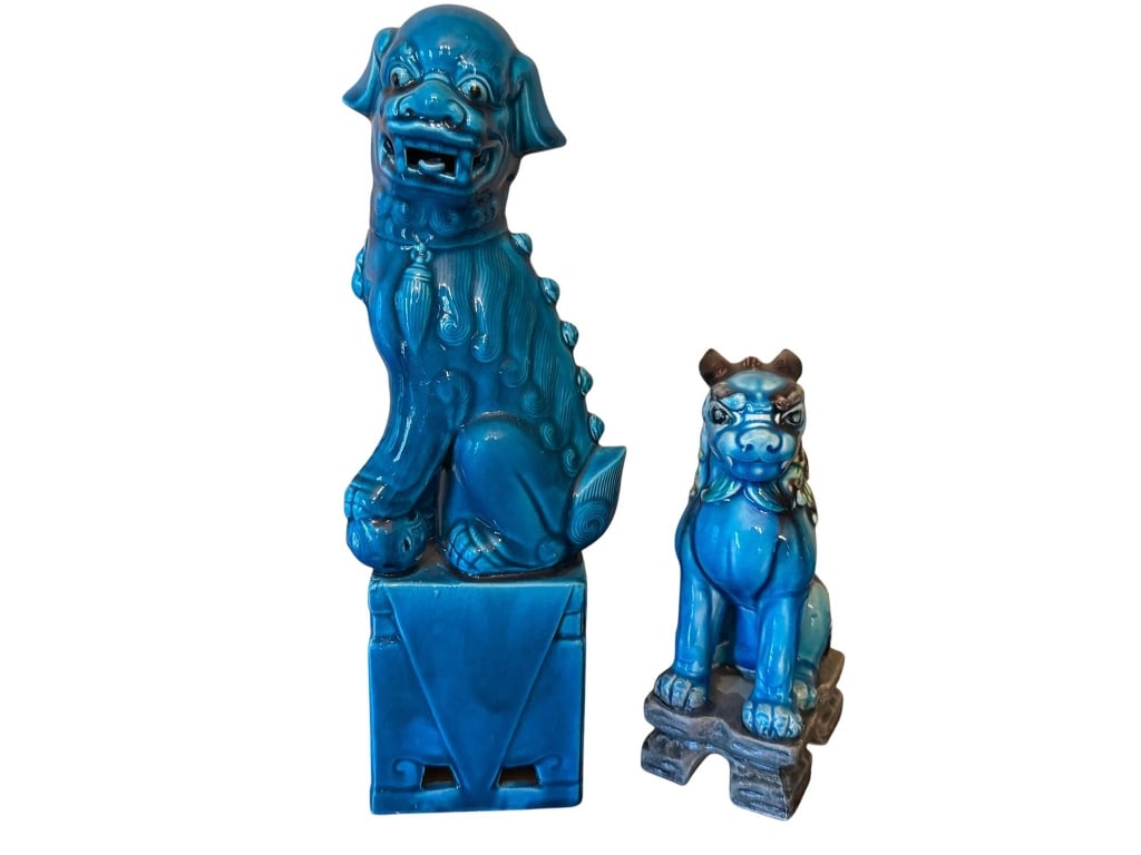 TURQUOISE CHINESE FOO DOGS: Two Chinese Foo dog figurines in turquoise glaze. Larger measures approximately 12 inches tall, the smaller about 8 inches. Both feature traditional guardian styling and vibrant color detail. Gentle w