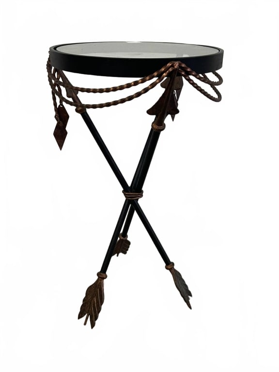 IRON AND GLASS SIDE TABLE 21": Side table has a round glass top with a decorative iron frame. The tripod base features unique arrow-shaped feet and twisted rope detailing. Suitable for eclectic or classic interiors, it combines fun