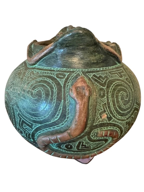 HAND-CRAFTED CERAMIC POT WITH SNAKE MOTIF: This is a hand-crafted ceramic pot featuring an incised and raised snake design. The exterior showcases intricate geometric patterns and swirling motifs, with a prominent snake figure in relief. The s