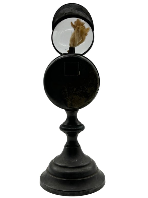 ANTIQUE BULLSEYE LENS OIL SHIP SPOT LAMP 11": Antique Newton bullseye lens oil lamp featuring a black japanned-style metal body, round convex glass lens, hinged hood marked NEWTON, exposed wick chamber, and turned pedestal base. This unusual deco