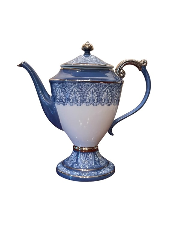 BOMBAY BLUE AND WHITE TEAPOT WITH LID 10": Porcelain teapot by Bombay, marked 'Made in China.' Features intricate blue and white pattern with gold accents, pedestal base, and an elegant handle and spout. Measures approximately 10" wide and