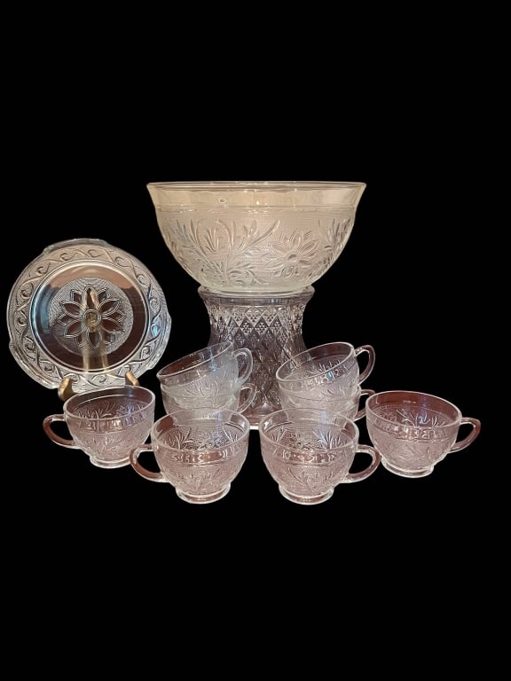 VINTAGE PRESSED GLASS PUNCH SET WITH CUPS 10": Vintage pressed glass punch set including a large punch bowl, stand, round serving tray, and six matching handled cups. All pieces feature elaborate floral and geometric designs. Great for entertainin