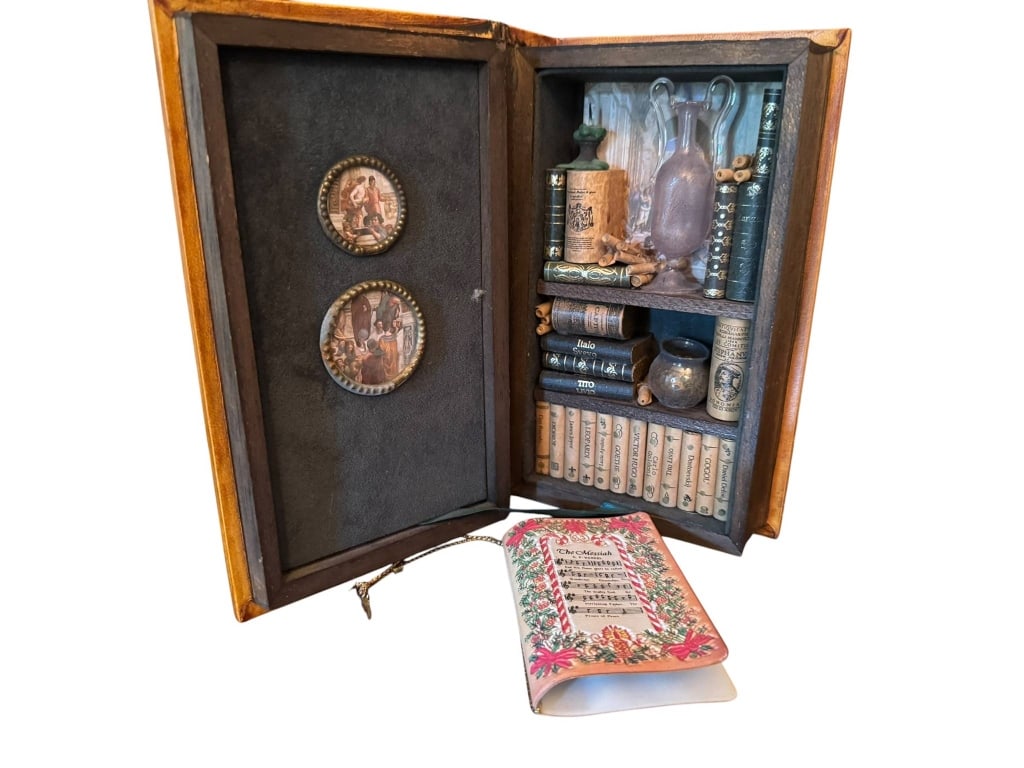 ANTIQUE BOOK FORM LIQUOR CABINET MANZONI: Antique book-shaped case titled 'Promessi Sposi Manzoni' concealing a miniature liquor cabinet with glassware and bottles. Beautifully detailed cover with ornate gold accents, measuring approximately 