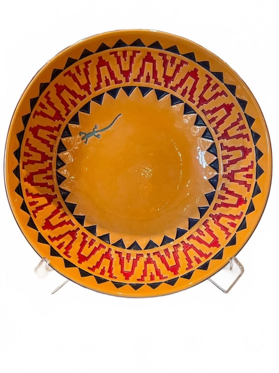 WESTERN DECORATIVE BOWL BY T.S. WOODRUFF 1993 16": Colorful glazed ceramic bowl signed by T.S. Woodruff and dated 1993. Features geometric red and blue border design, an orange interior with sculpted lizard motif. Measures approx. 16" diameter and 5"