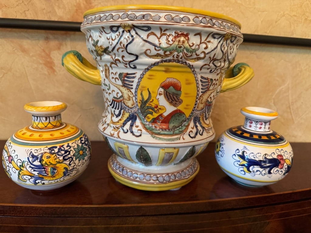 ITALIAN DERUTA STYLE HAND-PAINTED POTTERY SET: Three Italian Deruta-style hand-painted pottery pieces. Includes large handled urn with portrait medallion and two smaller vases with animal motifs. Ornate detailing and vibrant colors. Urn marked on 