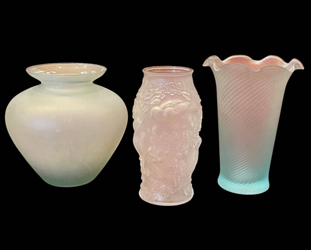 3 FROSTED ART GLASS VASES 10": 3 iridescent frosted glass vases: one with ruffled rim and ribbed texture, one with bird and floral motif relief, and a wide rounded vase. All glasses are a translucent color, they appear to be pastel