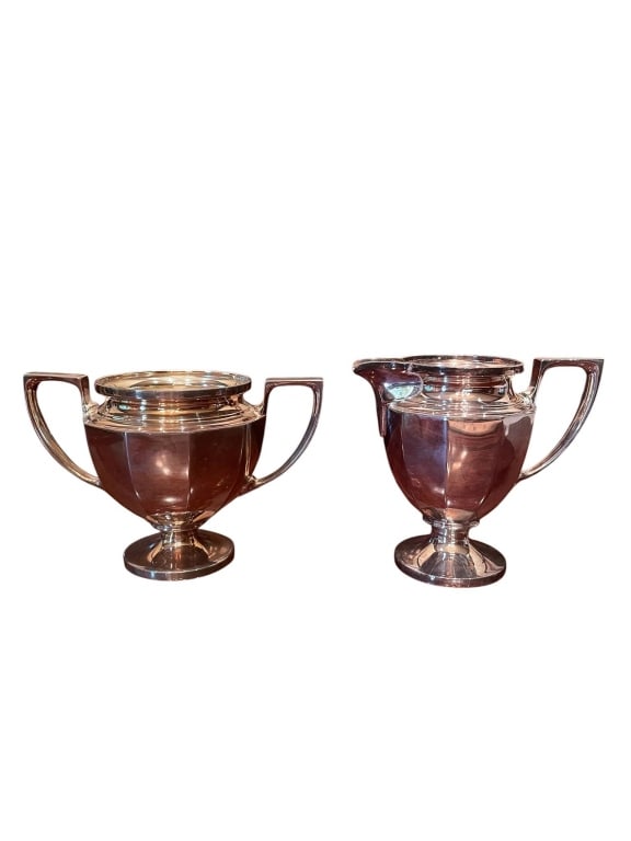 VINTAGE UNIVERSAL SILVERPLATE CREAMER AND SUGAR SE: Vintage Universal EPNS (Electroplated Nickel Silver) creamer and sugar bowl set. Both pieces feature art deco styling with geometric handles and pedestal bases. The sugar bowl and creamer each measure