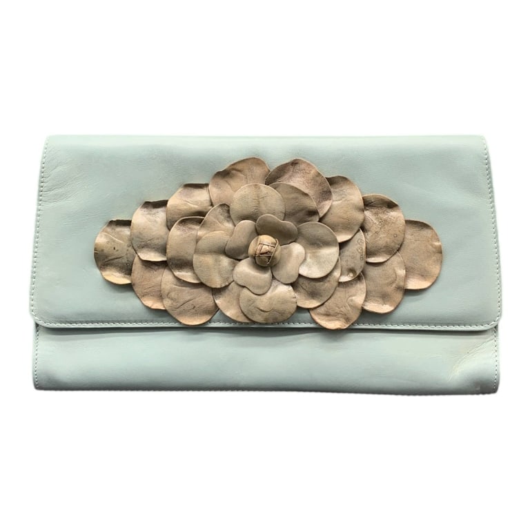 PAOLO MASI BLUE LEATHER FLORAL CLUTCH 11": Paolo Masi clutch in pale blue leather featuring an elegant layered leather flower applique on the front. Interior lined with signature fabric, includes zip and open compartments. Approx. 11" wide, ma