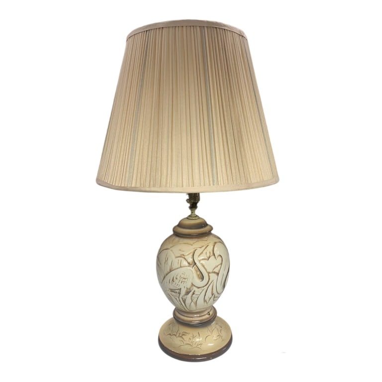 VINTAGE CERAMIC TABLE LAMP WITH BIRD MOTIF 28": Ceramic table lamp featuring a decorative bird motif on the base. The lamp includes a harp and a pleated fabric shade. The body is finished in beige hues with carved detailing and a wooden circular ba