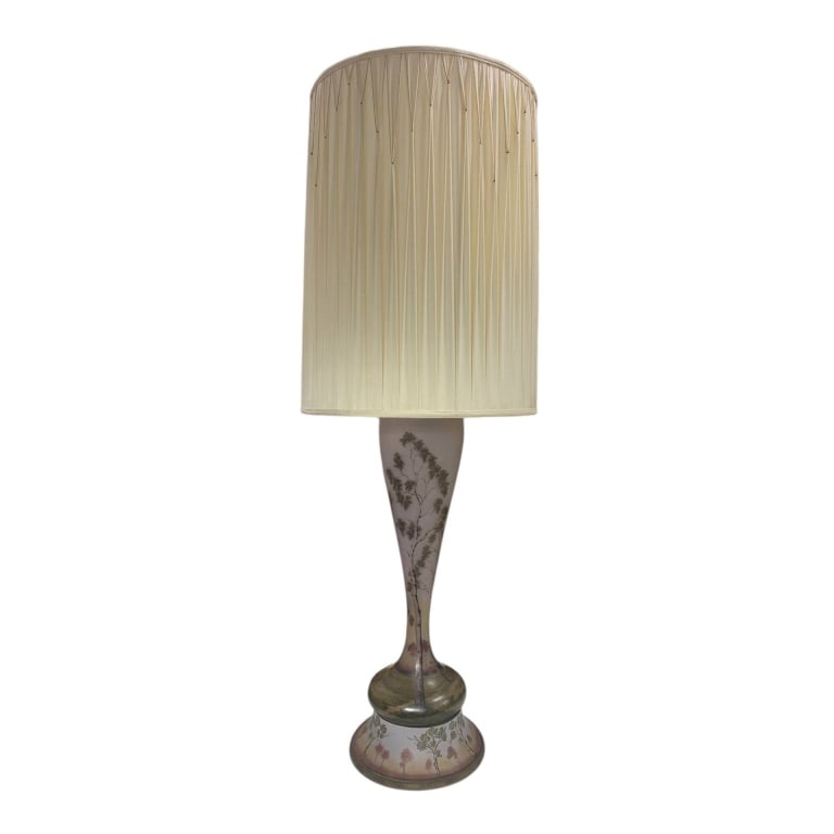 GLASS TABLE LAMP WITH FLORAL DESIGN 38": Glass table lamp featuring a floral design on the base and a tall pleated fabric lampshade. The lamp includes a metal neck and electrical fitting for standard use. Shade and lamp are both present. App