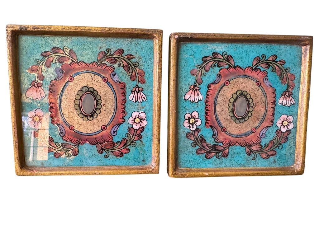 PAIR HAND PAINTED FLORAL DECORATIVE TRAYS: Hand painted square trays with ornate floral motifs in pink and white on a turquoise background. Each tray measures about 4 inches wide and 1 inch deep, with gold trim and felt pads on the base. Attra