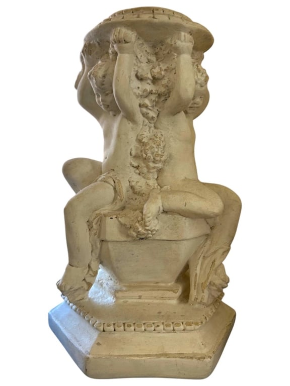 VINTAGE MONTICELLO STUDIO CHERUB PEDESTAL: Vintage Monticello Studio plaster pedestal featuring three cherubs holding up a decorative platform. Height is approximately 14 inches. Surface shows signs of wear and paint loss, consistent with age.