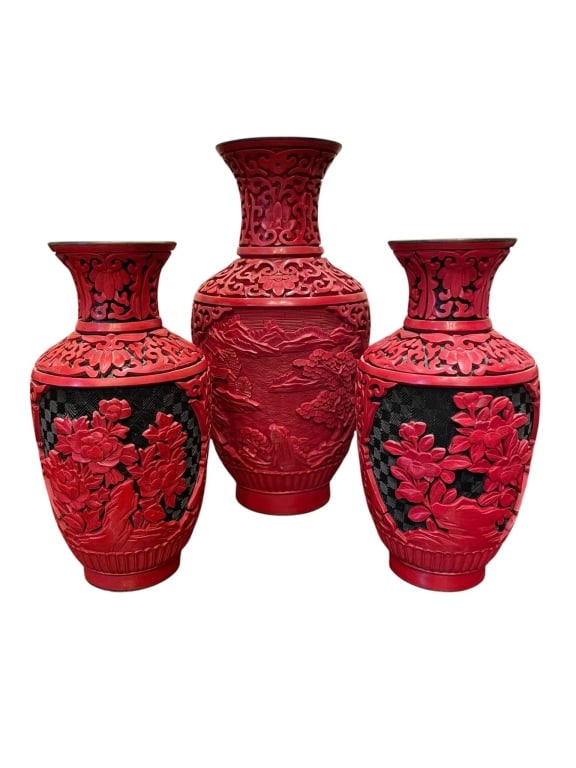 THREE CHINESE CINNABAR VASES 9": Three intricately carved Chinese cinnabar vases with floral and landscape motifs. Featuring traditional red lacquer finish and gilt-rimmed tops. Tallest vase approximately 9 inches high. Excellent dec