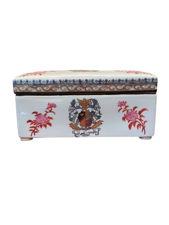 CHINESE PORCELAIN BOX WITH HERALDIC CREST 8": Rectangular porcelain trinket box, Chinese export box. Features floral decoration and a European armorial crest on the lid and sides. Measures approx. 8 inches tall. Remains in good condition.