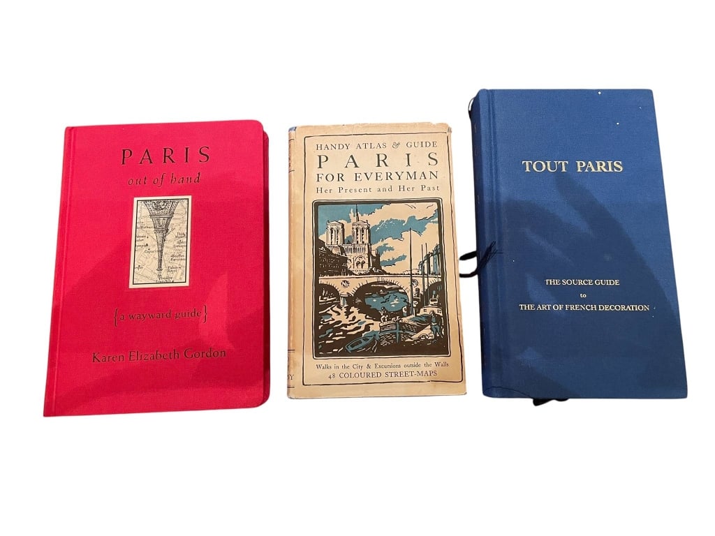 THREE VINTAGE PARIS GUIDEBOOKS: Three vintage Paris guidebooks, including 'Paris Out of Hand,' 'Paris for Everyman,' and 'Tout Paris.' Each book features maps and information about Paris, ideal for collectors or travel enthusiasts. 
