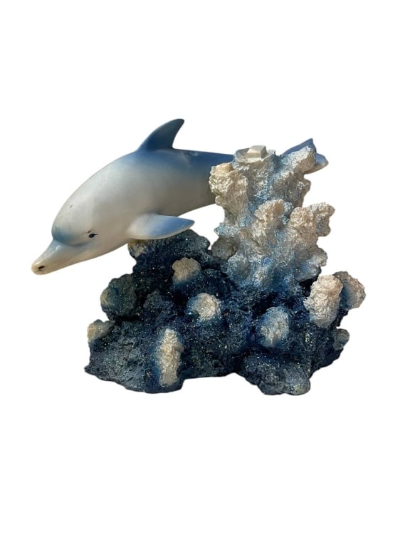 CERAMIC DOLPHIN ON CORAL REEF FIGURINE 6": Decorative ceramic dolphin figurine on a textured coral reef base, hand-painted in shades of blue and white. Measures approximately 6 inches high and 7 inches wide. Features non-slip pads on the botto