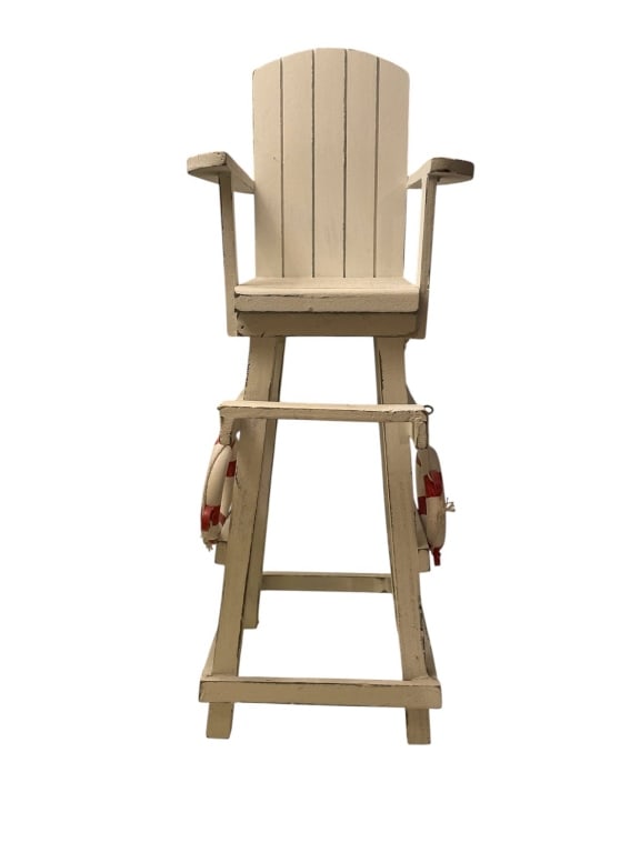VINTAGE MINIATURE LIFEGUARD CHAIR MODEL 14.5": Vintage miniature lifeguard chair model in white wood, featuring armrests and a slatted back. It is accented with two small life rings attached to the sides. The chair measures approximately 14.5 inch