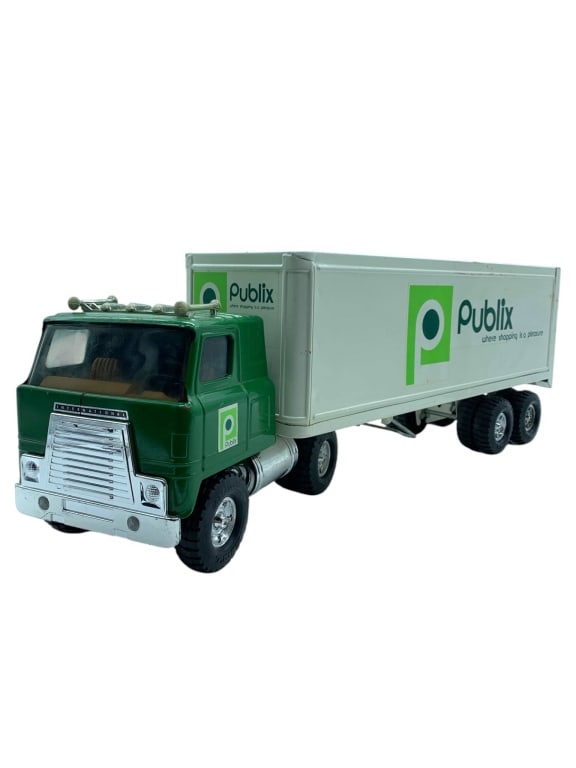 VINTAGE PUBLIX TOY DELIVERY TRUCK 21": Vintage Publix branded semi truck and box trailer toy featuring a green International cab with chrome-style grille, bumper, fuel tank, vertical exhaust stack, roof horns, black rubber-style tires, and