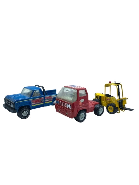 VINTAGE TONKA TOY LOT WITH PICKUP, CAB & FORKLIFT: Vintage model trucks featuring three collectible pieces: a blue Tonka pickup truck with striped side graphics, a red Tonka semi cab, and a yellow Tonka forklift with black forks and Tonka branding. Th