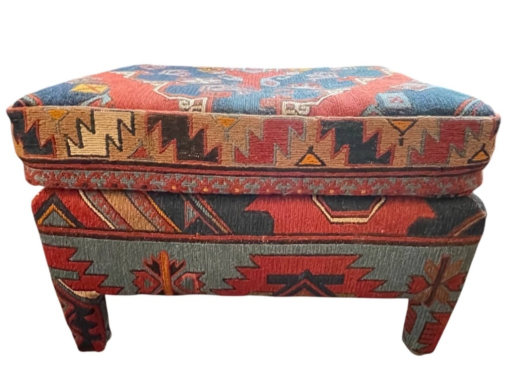 VINTAGE KILIM UPHOLSTERED OTTOMAN 24": This vibrant vintage ottoman bench is upholstered in traditional kilim fabric featuring intricate geometric patterns in red, blue, and earth tones. Perfect as a stylish accent or functional seating. |