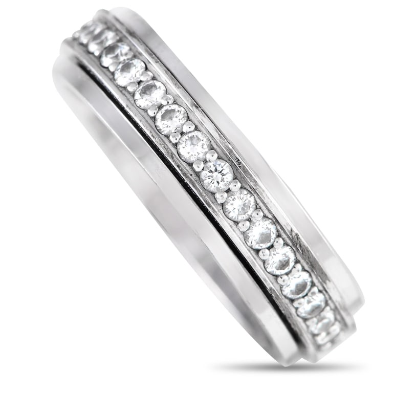PIAGET POSSESSION 18K WHITE GOLD 0.24CT DIAMOND RI: A captivating ring of extraordinary style, here is Piaget's Possession ring in white gold glittering with 0.24 carats of brilliant diamonds. This stylish ring features a central turning band that shim