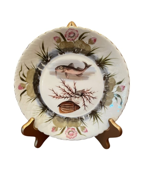 VINTAGE HANDPAINTED FISH AND SHELL PLATE 8": Vintage Porcelain plate, handpainted with fish, shell, and aquatic plants. Features hand-painted floral border with gold trim. Approximately 8"