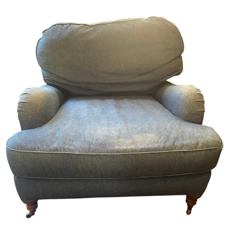 OVERSIZED BLUE ARMCHAIR WITH WOODEN LEGS 44": Oversized upholstered armchair in blue fabric with plush cushioning. Features turned wooden legs with casters. Measurements shown: approximately 33 inches tall, 36 inches wide, and 44 inches deep. Com